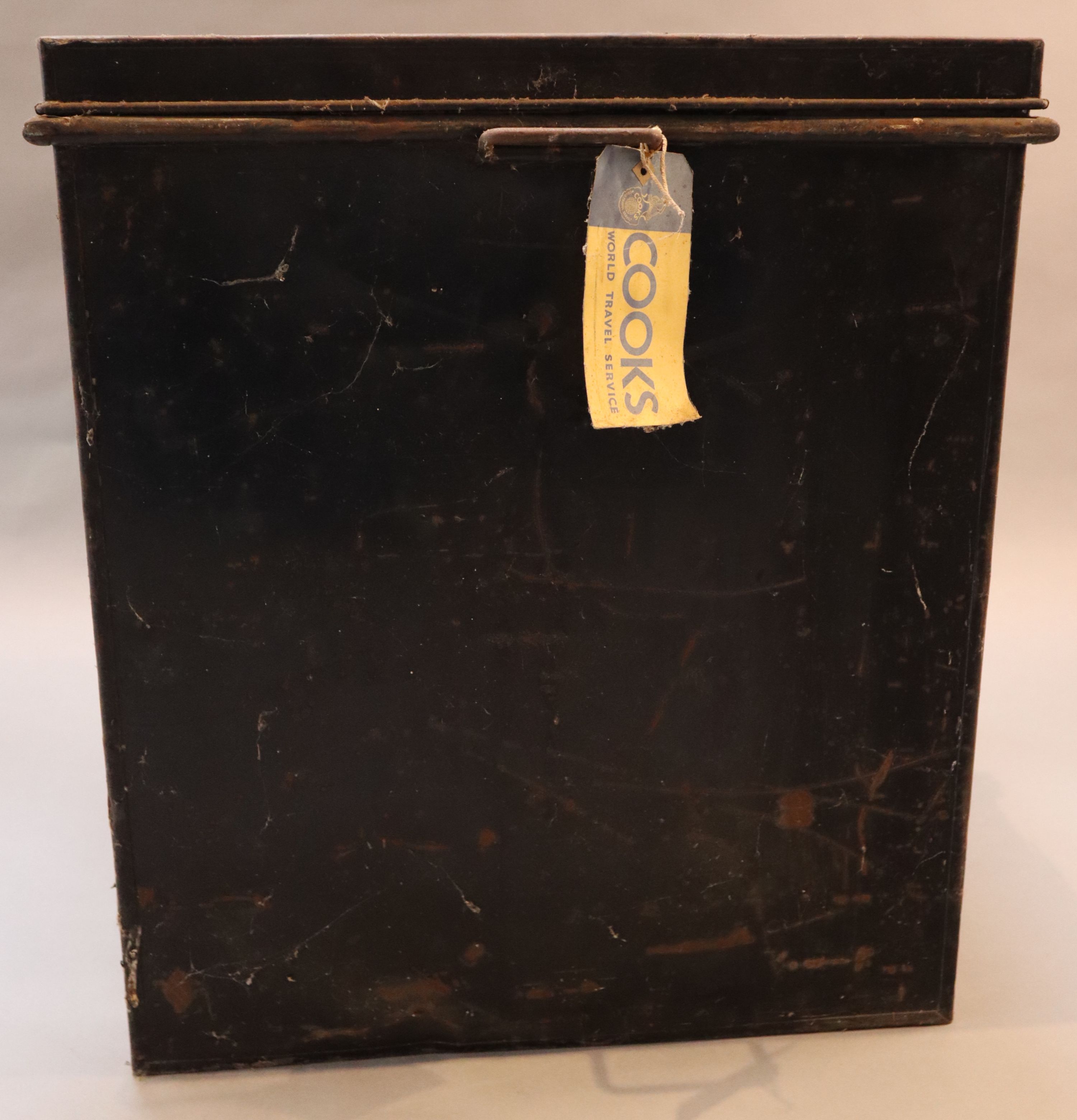 An early 20th century black painted tin travelling trunk, inscribed Lady Brabourne with old British India and Cooks Travel labels, wi